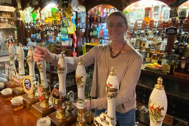 Judith Burr, who has run The Barley Mows for 15 years, pours a pint as she welcomes customers back into her pub as lockdown eased. Photo: Tom Cotterill