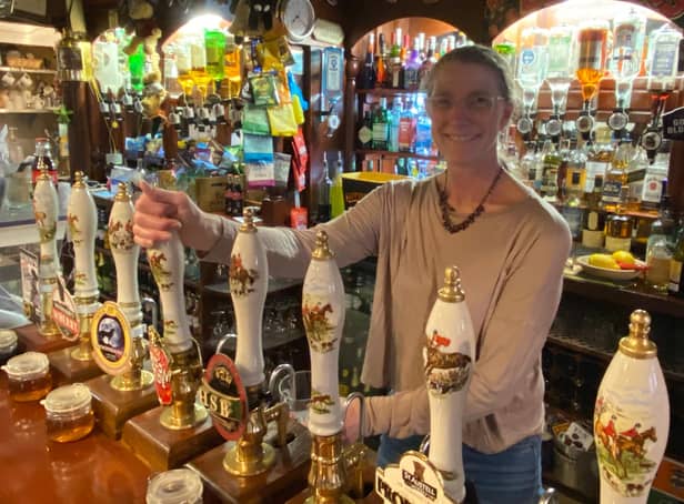 Judith Burr, who has run The Barley Mows for 15 years, pours a pint as she welcomes customers back into her pub as lockdown eased. Photo: Tom Cotterill
