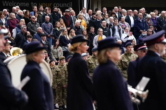 Members of the public stand silent as a mark of respect during the two minutes silence at the Remembrance Service at the Guildhall Square, in Portsmouth. Picture date: Sunday November 14, 2021.