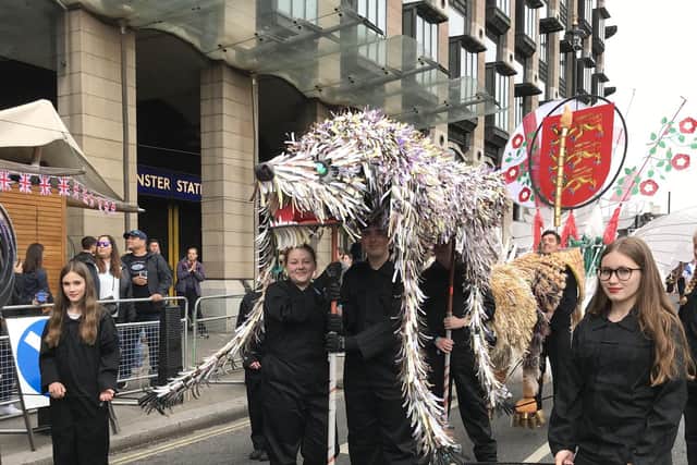 Gosport students perform in front of The Queen at the Platinum Jubilee Pageant by carrying wolfhound and snake. Picture: Tom Barnes.
