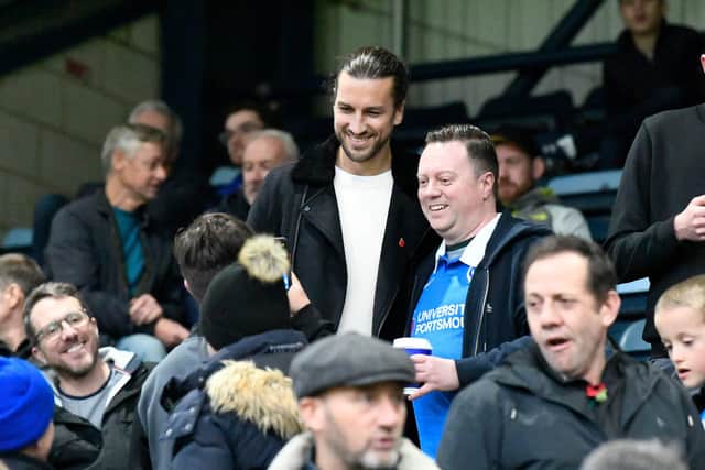 Former Pompey defender Christian Burgess poses for a picture with a Blues fan at Adams Park.