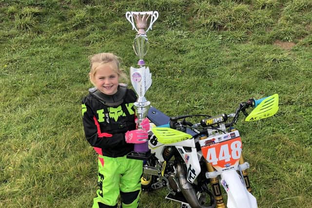 Lilly Senior, 7, with her UK Girls Motocross trophy