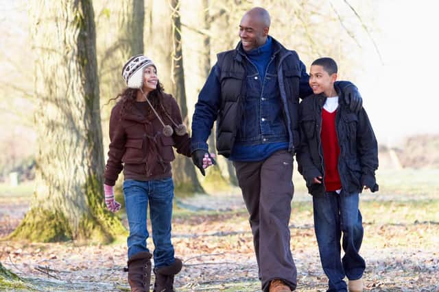 A generic stock photo of a dad out walking with his children. Credit: PA