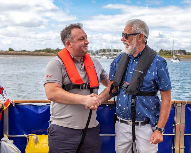 Liam Dobbin from Superyacht Charities, who donated £3,500 to help with mooring fees, with David Weinstock, Secretary of Sailing Therapy. Picture: Mike Cooter (200822)