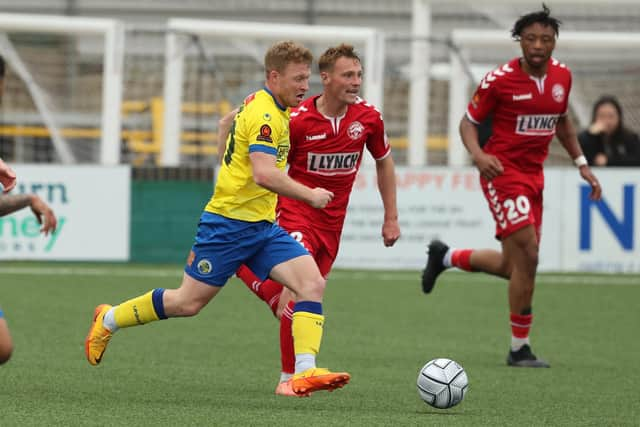 Tommy Wright (yellow) in action for Hawks against Hampton and Richmond last season. Picture by Dave Haines