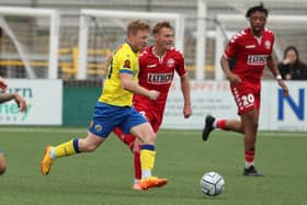 Tommy Wright (yellow) in action for Hawks against Hampton and Richmond last season. Picture by Dave Haines