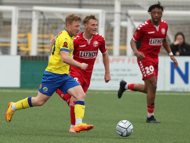 Tommy Wright (yellow) in action for Hawks against Hampton and Richmond last season. Picture by Dave Haines