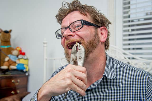 Chris Savage with the wrench and the teeth that he pulled out in his home in Milton, Portsmouth.
Picture: Habibur Rahman