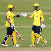 Ben McDermott, left, and James Vince bump fists on their way to a new Hampshire first wicket record stand in the T20 Blast against Sussex. Photo by Warren Little/Getty Images.