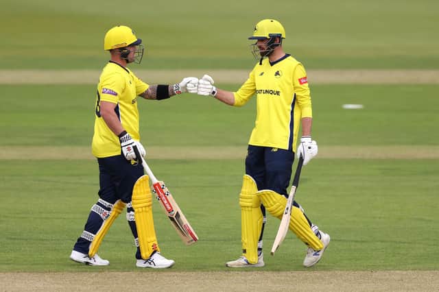 Ben McDermott, left, and James Vince bump fists on their way to a new Hampshire first wicket record stand in the T20 Blast against Sussex. Photo by Warren Little/Getty Images.