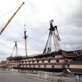 A crane begins the process of removing the main lower mast from HMS Victory at Portsmouth Historic Dockyard in Portsmouth. Picture Andrew Matthews/PA Wire