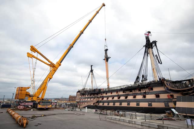 A crane begins the process of removing the main lower mast from HMS Victory at Portsmouth Historic Dockyard in Portsmouth. Picture Andrew Matthews/PA Wire