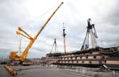 A crane begins the process of removing the main lower mast from HMS Victory at Portsmouth Historic Dockyard in Portsmouth. Picture Andrew Matthews/PA Wire