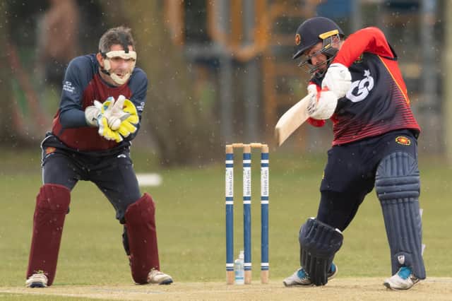 A masked Havant wicket-keeper Jeremy Bulled catches the ball as the rain falls against Hook & Newnham Basics.  Picture: Keith Woodland