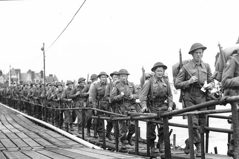 British troops on a temporary scaffolding pier alongside South Parade Pier. They are about to board an LCI(L) or Landing Craft, Infantry (Large) to take them to Normandy. Probably after D-Day.