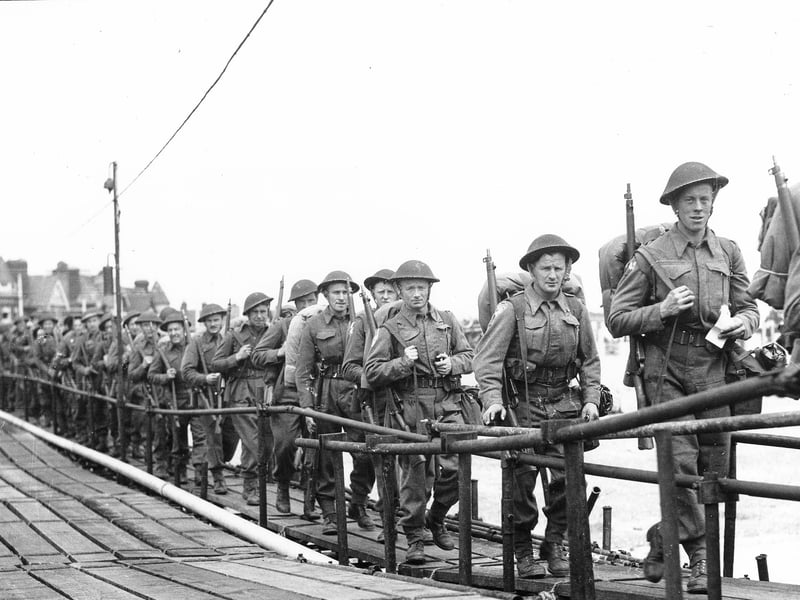 British troops on a temporary scaffolding pier alongside South Parade Pier. They are about to board an LCI(L) or Landing Craft, Infantry (Large) to take them to Normandy. Probably after D-Day.