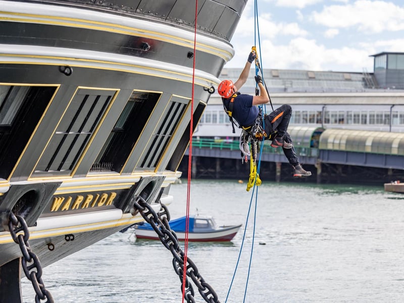 Firefighters practicing rescue from the sea, ascending by rope onto HMS Warrior during the UKRO event at Portsmouth Historic Dockyard. Picture: Mike Cooter (280924)