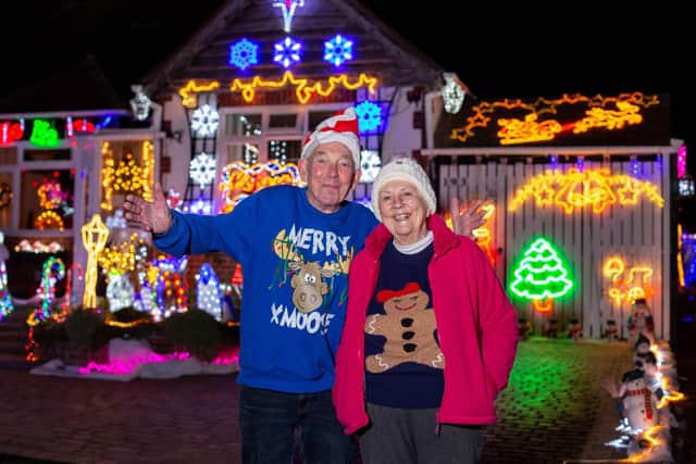 Barbara and Bill Wright have decorated their home with Christmas lights once again despite the cost of living crises to raise money for charity 

Pictured: Bill and BarbaraWright outside their home in Portchester, Portsmouth on Monday 12th December 2022

Picture: Habibur Rahman