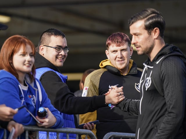 Joe Rafferty talks to these fans before focusing on the game