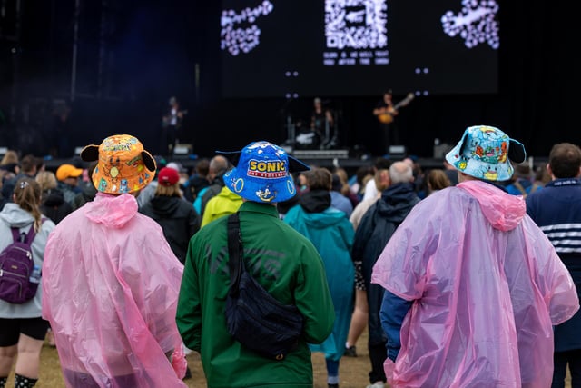 Watching the Tors on stage despite the downpour. Picture: Mike Cooter (240824)