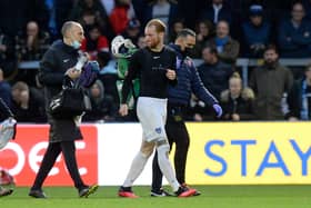 A bloodied Connor Ogilvie is given treatment at Wycombe.