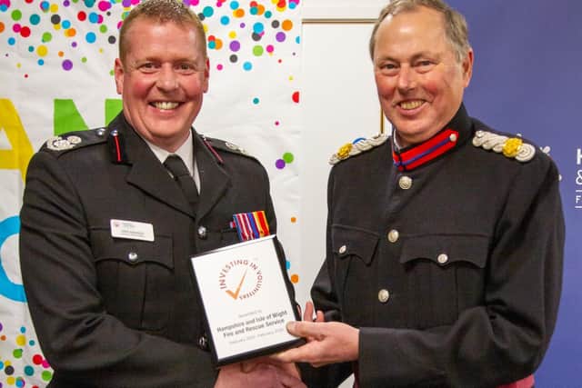 Deputy Lieutenant for Hampshire, Tom Floyd, presents Assistant Chief Fire Officer Stewart Adamson with an ‘Investing in Volunteers’ plaque