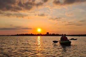 Kayaking next to the crane at sunset near Portchester Castle taken by Alex Yorke
