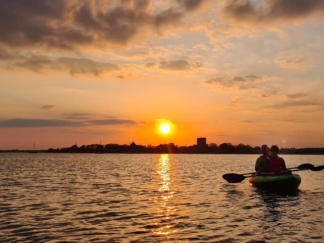 Kayaking next to the crane at sunset near Portchester Castle taken by Alex Yorke