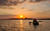 Kayaking next to the crane at sunset near Portchester Castle taken by Alex Yorke