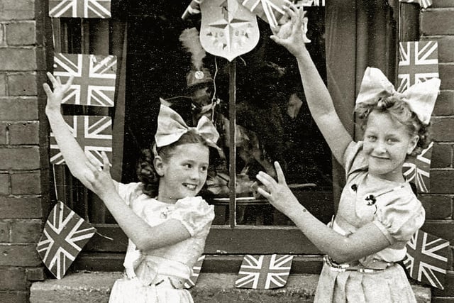 Festival of Britain street tea outside 14, Moorland Road Buckland Portsmouth. Kay Britno 9yrs on left & friend from Madame Selwood's dance troop 
outside her grandparents house entertaining the neighbours at a Festival of Britain street party in 1951