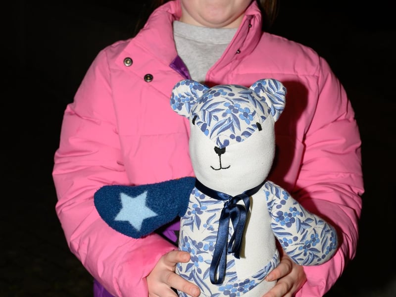 Holly Martin, god daughter to Elin, with her memory bear made out some Elin's clothes.