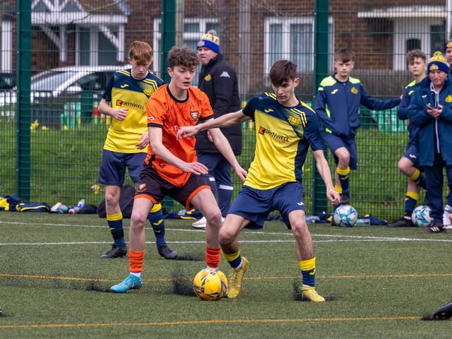 Action from the 2-2 draw between the under-18s of Moneyfields (blue/yellow kit) and AFC Portchester (orange/black kit). Picture: Mike Cooter