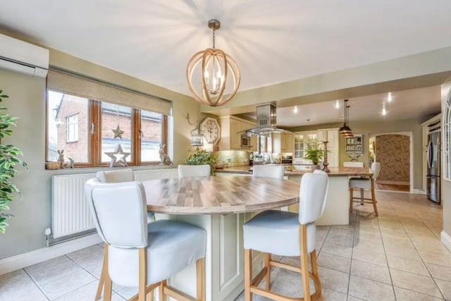 The listing says: "Approached over a generous gravelled driveway allowing parking for several vehicles and steps up to a front veranda and front door into the central hallway which immediately reflects the immaculate presentation offered."