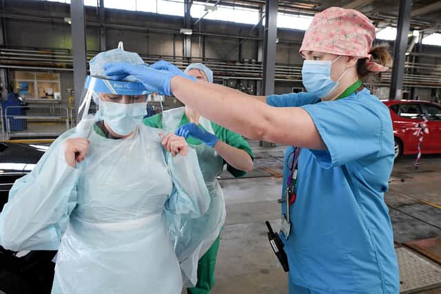 Medical staff put on their personal protective equipment (PPE). Picture: Justin Kernoghan/PA Wire