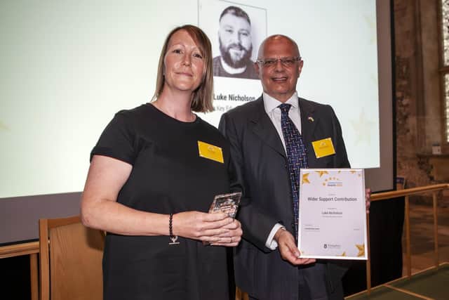Vicky Briant collects the Wider Support Contribution Award  on behalf of Luke Nicholson.