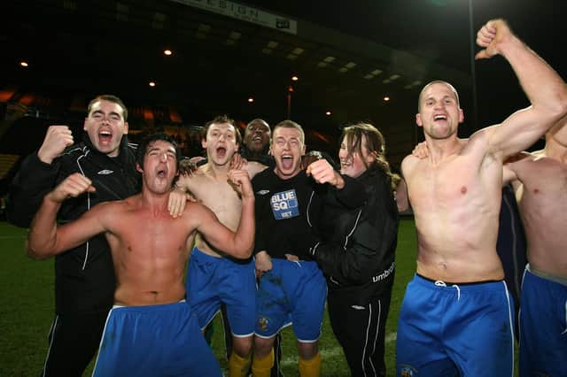 Brett Poate (second left) celebrates after Hawks' FA Cup win at Notts County in December 2007.