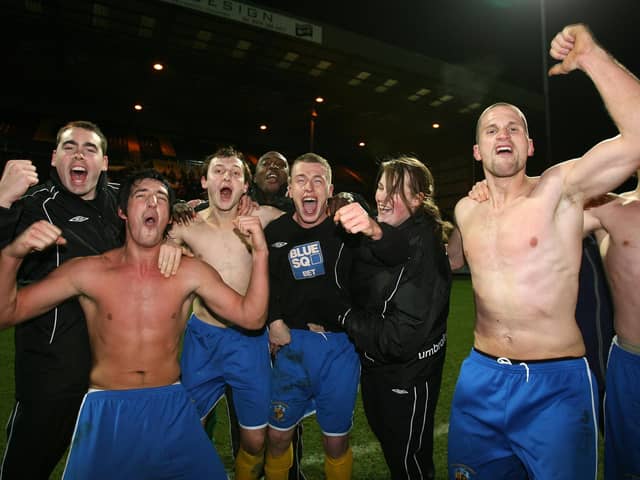 Brett Poate (second left) celebrates after Hawks' FA Cup win at Notts County in December 2007.