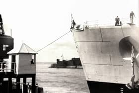 The bow of HMS Vanguard just yards from the old customs watch house. Picture: Courtesy of Deane Clark.