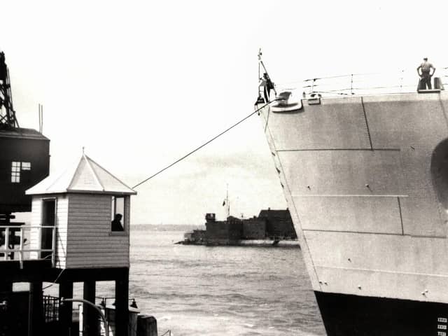 The bow of HMS Vanguard just yards from the old customs watch house. Picture: Courtesy of Deane Clark.