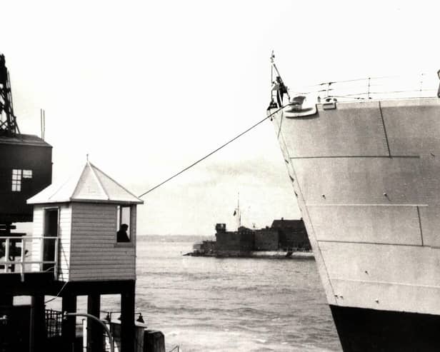 The bow of HMS Vanguard just yards from the old customs watch house. Picture: Courtesy of Deane Clark.
