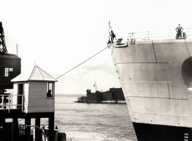 The bow of HMS Vanguard just yards from the old customs watch house. Picture: Courtesy of Deane Clark.