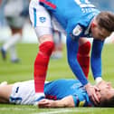 Ronan Curtis tends to Lee Brown following his hamstring injury against Burton