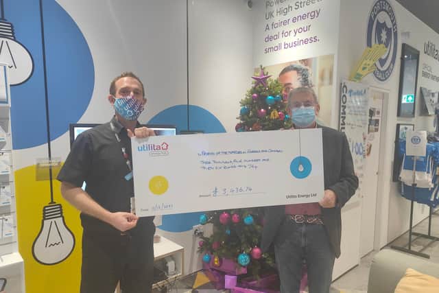 Robert Tait, Retail Manager at the Utilita Energy Hub in Gosport presents a £3,436 donation to Philip Rutt, Chair of Trustees for the Gosport Basics Foodbank.