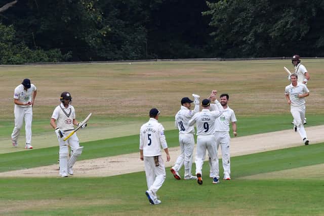 Ian Holland celebrates with Tom Alsop and Lewis McManus after dismissing Laurie Evans. Photo by Mike Hewitt/Getty Images.