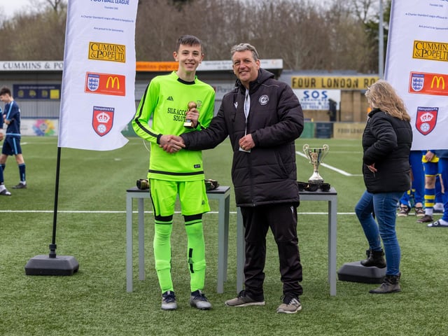 Cody Burchall receives the player of the match award from Scott Andrews, vice-chairman of the Portsmouth Youth Football League. Picture: Mike Cooter