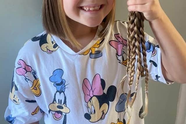 7-year-old Lexie Harding chops 13 inches of her long locks to donate to the Little Princess Trust.