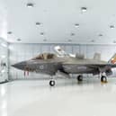Commanding Officer of 809 Naval Air Squadron Commander Nick Smith with an F-35 Lightning stealth jet. Pic: Joe Giddens/PA Wire