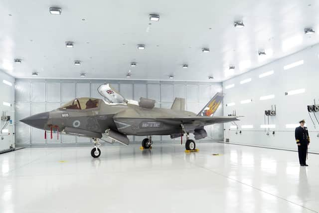 Commanding Officer of 809 Naval Air Squadron Commander Nick Smith with an F-35 Lightning stealth jet. Pic: Joe Giddens/PA Wire