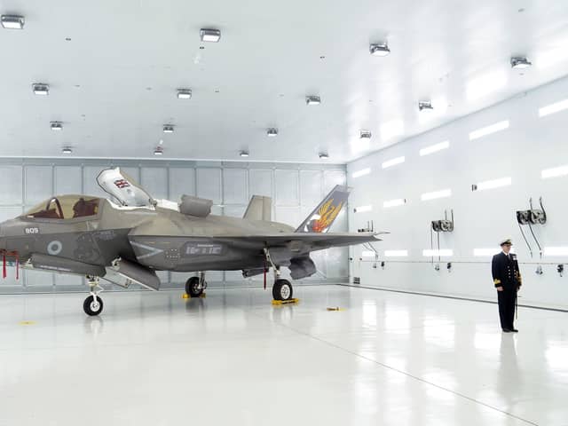 Commanding Officer of 809 Naval Air Squadron Commander Nick Smith with an F-35 Lightning stealth jet. Pic: Joe Giddens/PA Wire