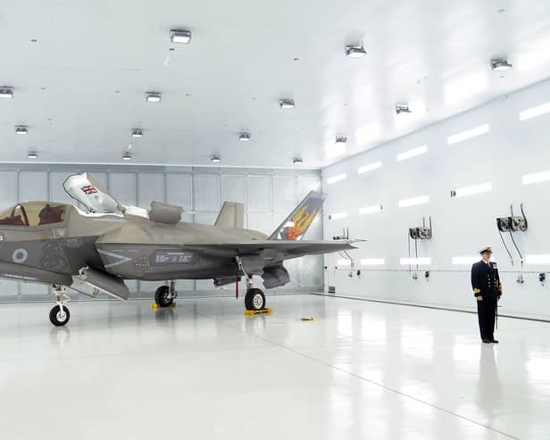 Commanding Officer of 809 Naval Air Squadron Commander Nick Smith with an F-35 Lightning stealth jet. Pic: Joe Giddens/PA Wire